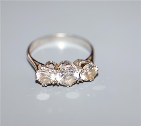 An 18ct white gold and paste-set three-stone ring, size O.